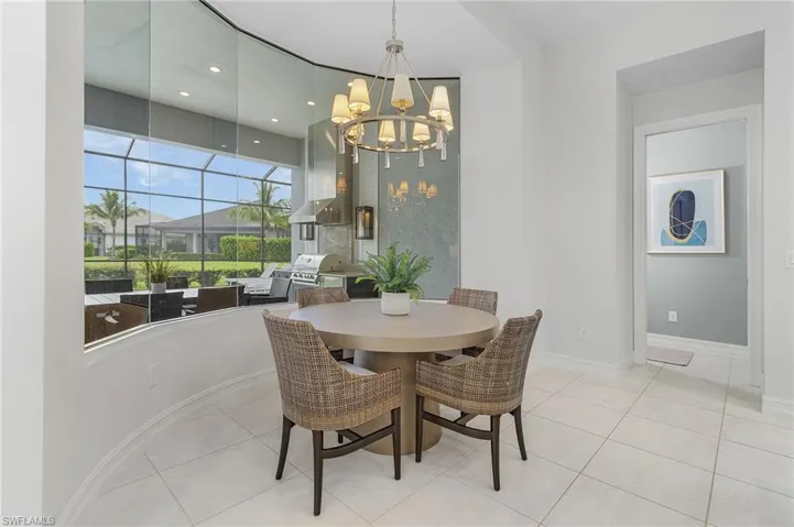 Dining area featuring light tile patterned floors, recessed lighting, and a chandelier