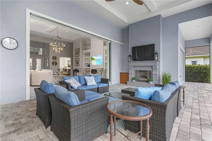 View of patio featuring an outdoor living space with a fireplace and a ceiling fan