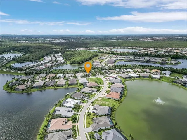 Aerial perspective of suburban area featuring a nearby body of water
