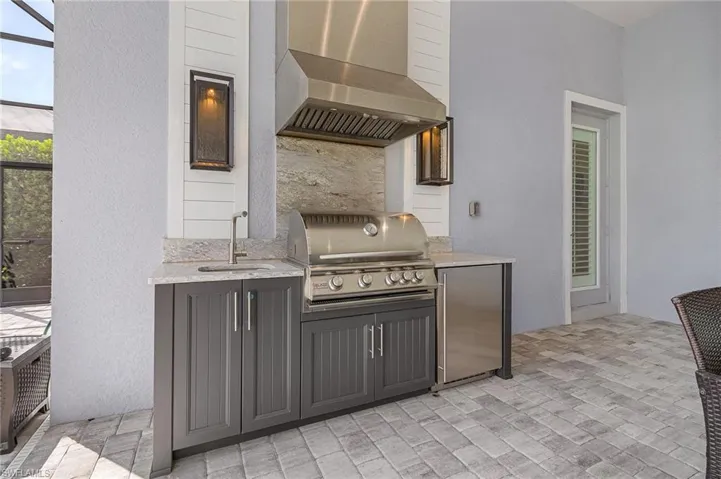 View of patio / terrace with exterior kitchen and a sink