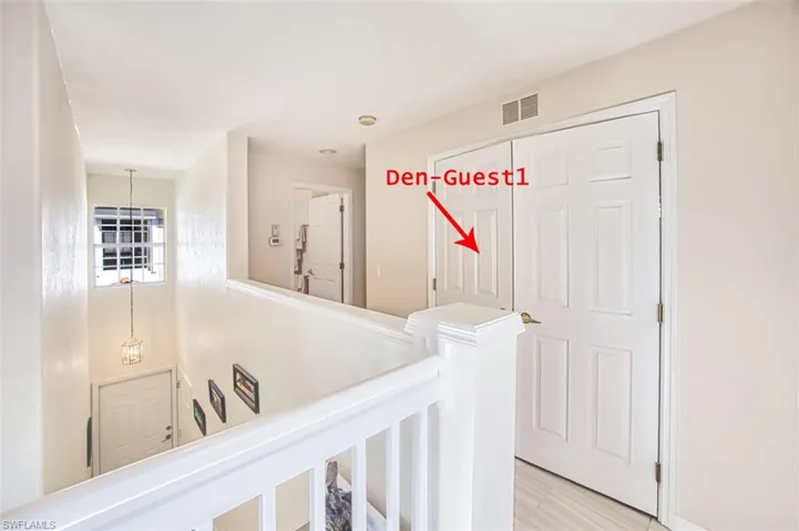 Corridor with an upstairs landing and light wood-style floors