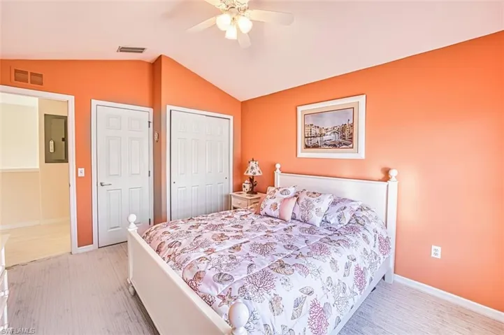Bedroom with lofted ceiling, a closet, and ceiling fan