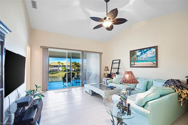 Living room featuring lofted ceiling and a ceiling fan