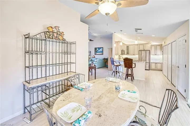Dining space with vaulted ceiling, ceiling fan, and recessed lighting
