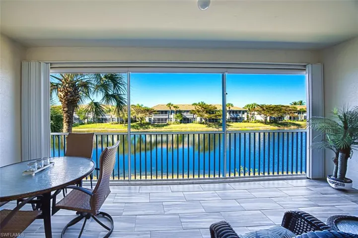 Sunroom featuring a water view