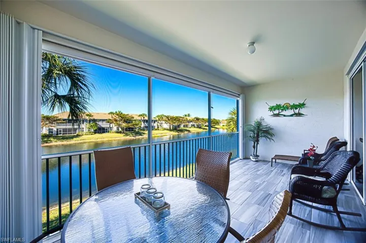 Sunroom with a water view and a residential view
