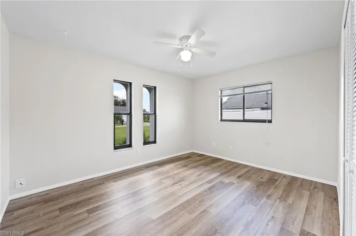 Unfurnished room featuring ceiling fan and light hardwood / wood-style flooring