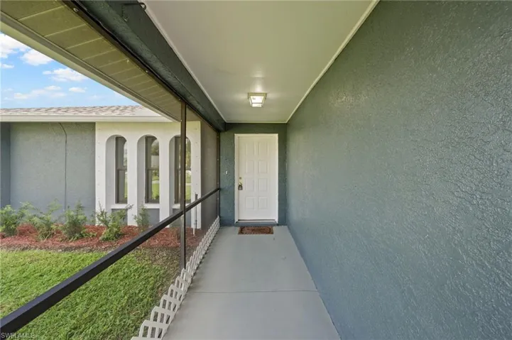 View of exterior entry featuring a balcony