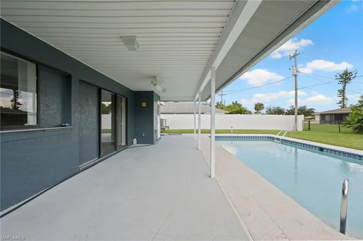 View of swimming pool featuring a lawn and a patio