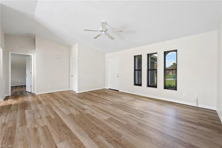 Unfurnished living room with light wood-type flooring and ceiling fan