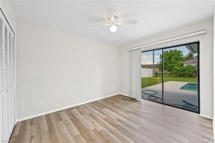 Unfurnished bedroom with light wood-type flooring, access to outside, ceiling fan, and a closet