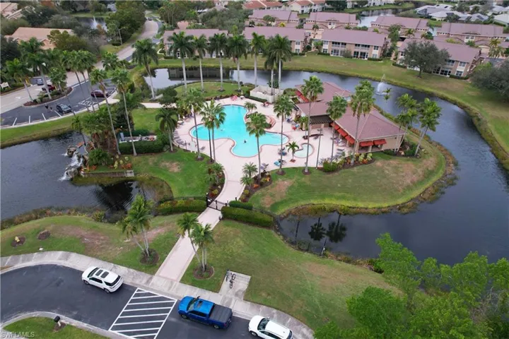 Aerial view of property's location with a large body of water and a pool