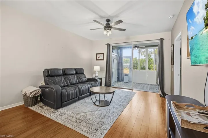 Living area with light wood-style floors and ceiling fan