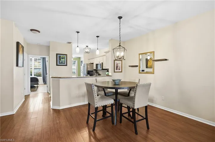 Dining room featuring dark wood finished floors and a chandelier