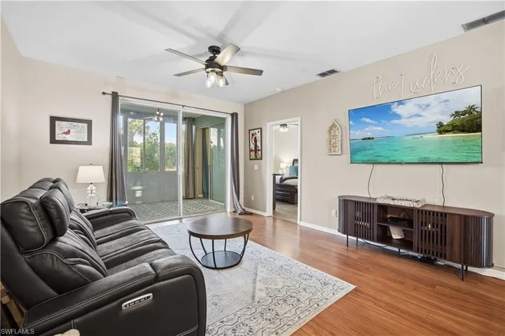 Living room with light wood-style floors and a ceiling fan