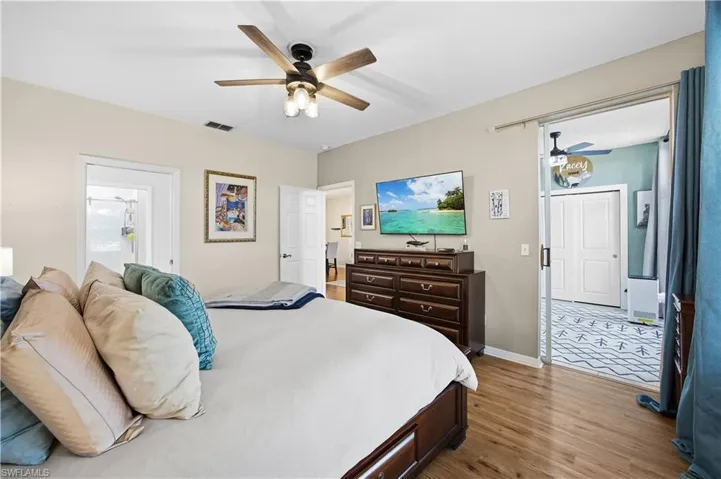 Bedroom with light wood-style floors and a ceiling fan