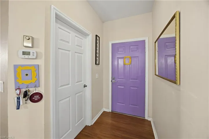 Doorway to outside featuring baseboards and wood finished floors