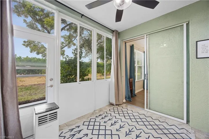 Unfurnished sunroom featuring a ceiling fan