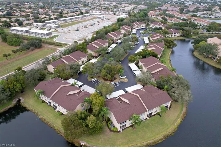Aerial view of property and surrounding area with a large body of water