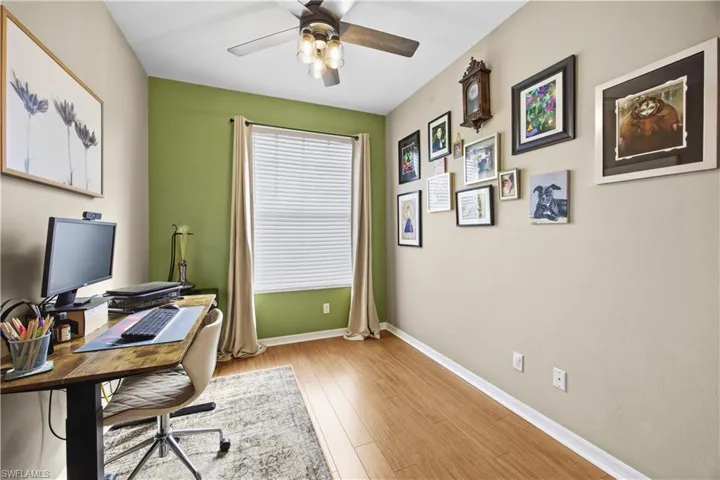 Office area featuring light wood finished floors and ceiling fan