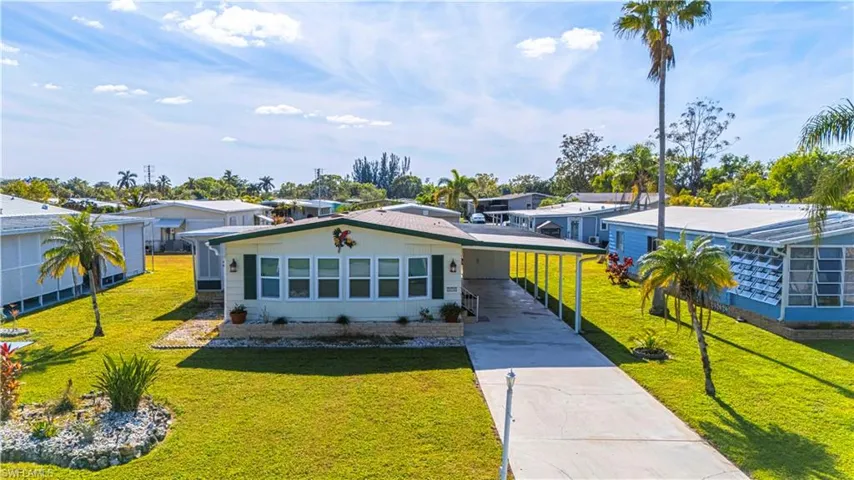 Ranch-style house featuring a front yard and a carport
