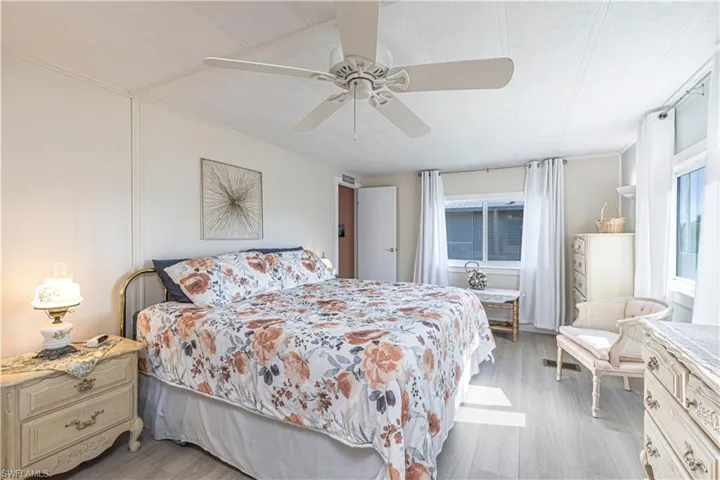Bedroom with ceiling fan and light hardwood / wood-style flooring