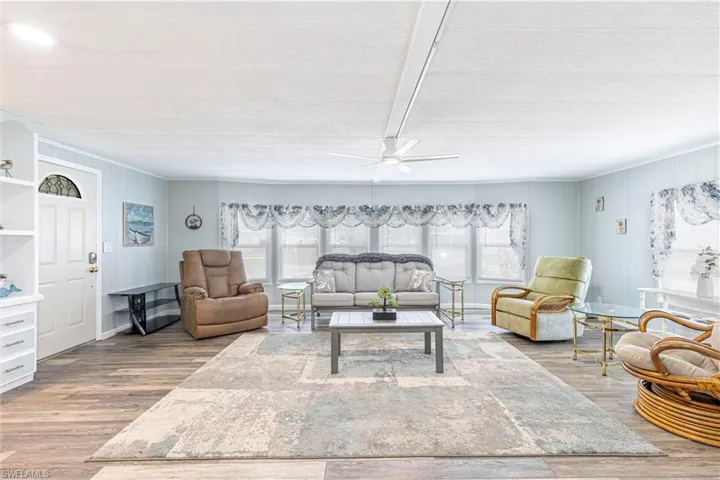 Living room featuring wood-type flooring and ceiling fan