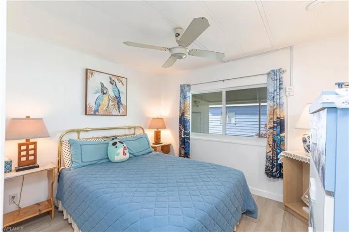 Bedroom with light hardwood / wood-style flooring and ceiling fan
