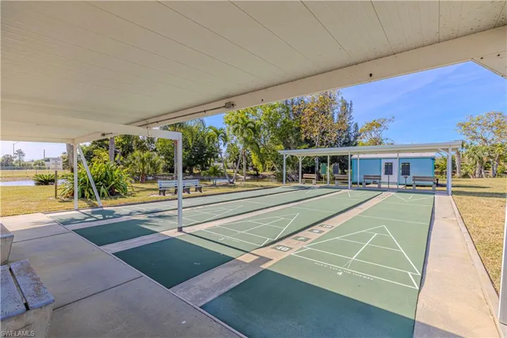 Surrounding community with a water view and a yard