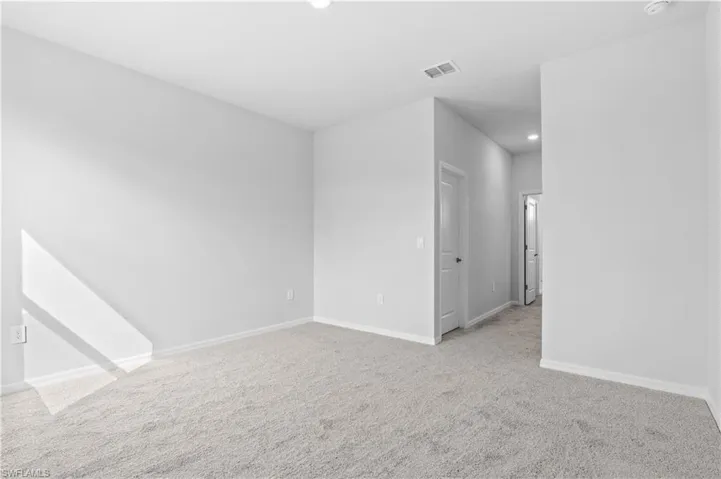 Unfurnished room featuring light colored carpet and recessed lighting
