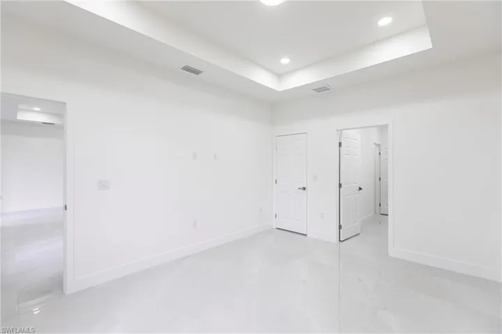 Unfurnished room featuring a raised ceiling