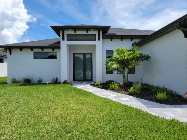 Entrance to property featuring a lawn