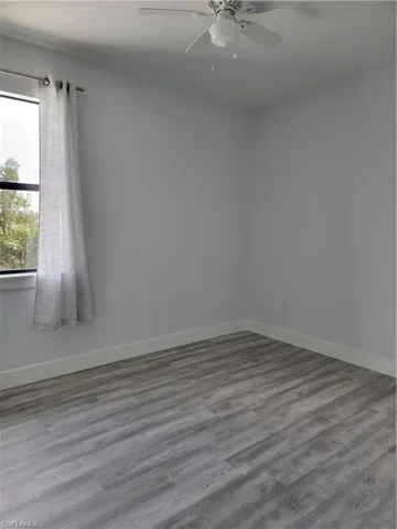 Spare room featuring hardwood / wood-style floors and ceiling fan