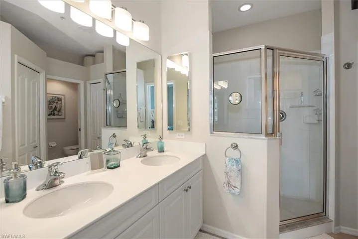 Double sinks, large mirror and shower.