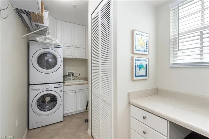 Spacious laundry room with storage and sink.