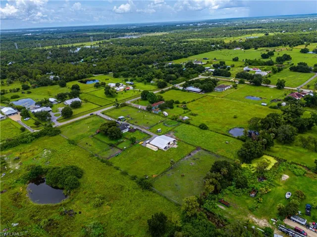Aerial view of property's location featuring a large body of water and rural landscape