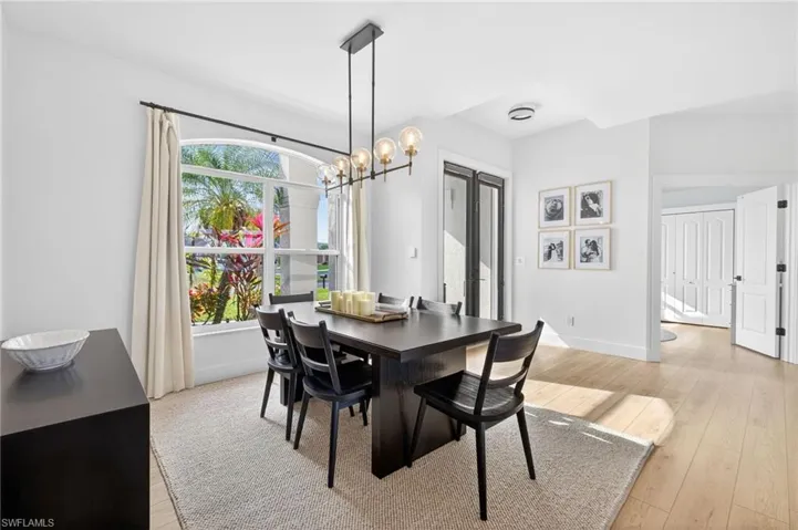 Formal dining area with light wood-style LVP floors and a chandelier