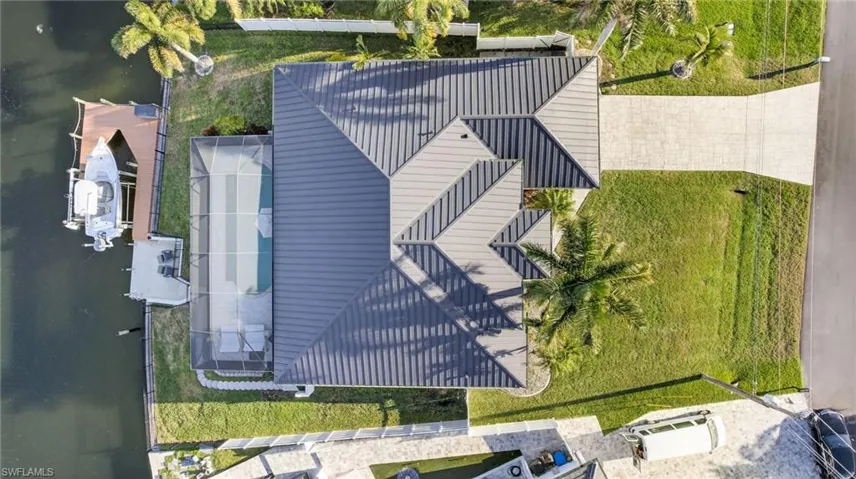 New standing seam metal roof (2023), .25 acre lot, fully fenced yard (2023), includes boat dock and lift with 2 new motors (2025)