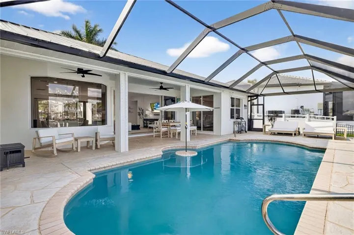 Outdoor entertaining featuring heated swimming pool, dining area, new enclosure (2023)