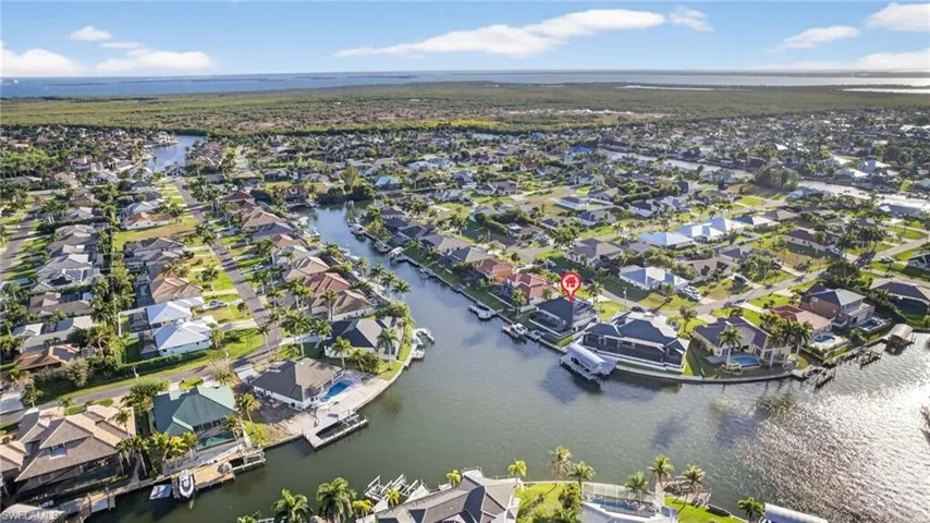 Aerial perspective of suburban area with a large body of water and gulf access