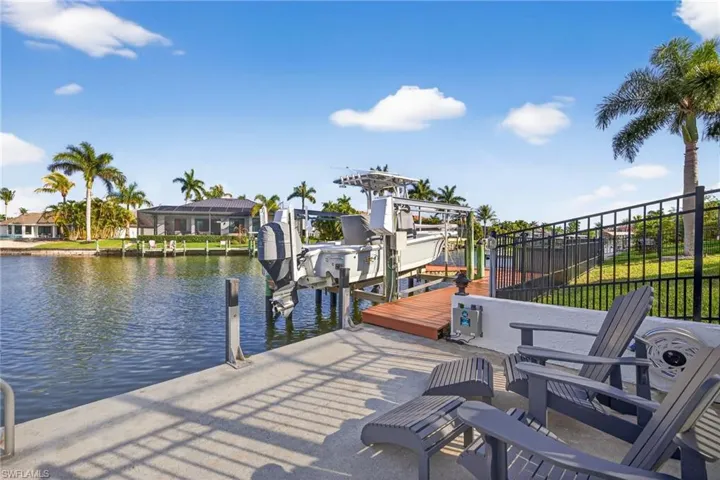 Seating area to watch for manatee & dolphins, Dock with boat lift and a water view