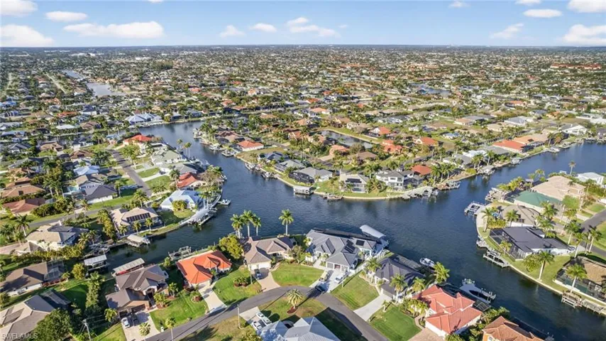 Aerial view of property location featuring intersecting canals, minutes to Cape Harbour, gulf access