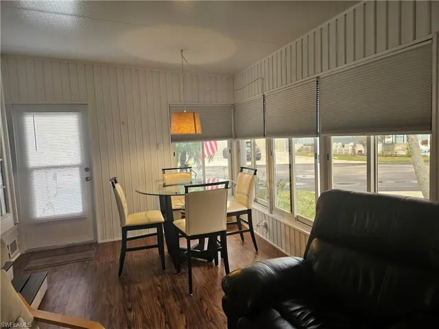 Dining space with wood-type flooring and wooden walls