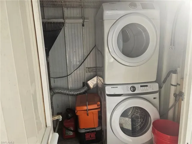 Clothes washing area with stacked washer / drying machine