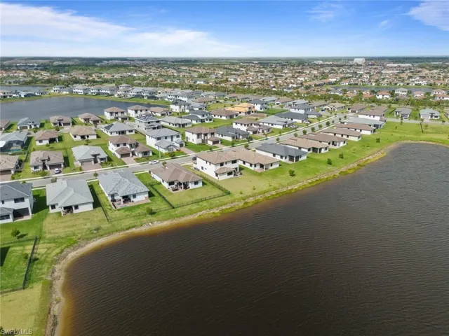 Drone / aerial view with a water view and a residential view