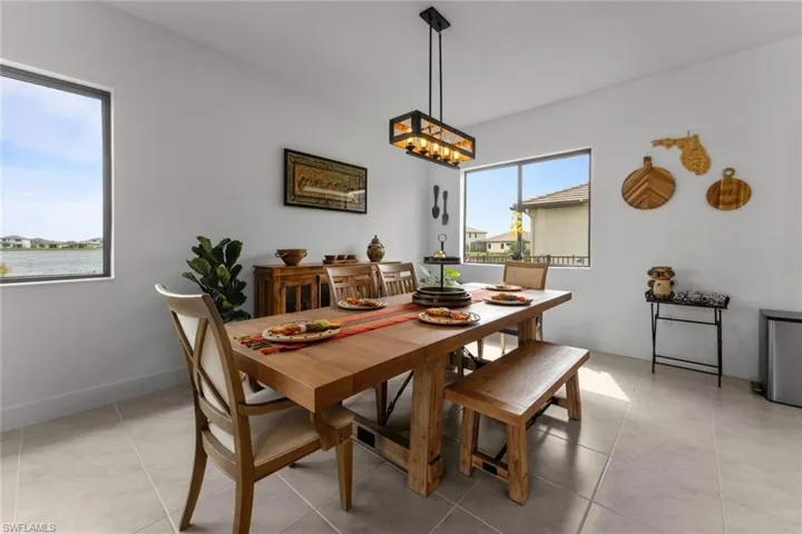 Dining space with baseboards and light tile patterned floors
