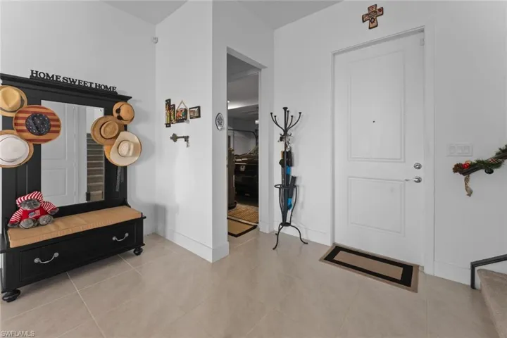 Mudroom with light tile patterned flooring and baseboards