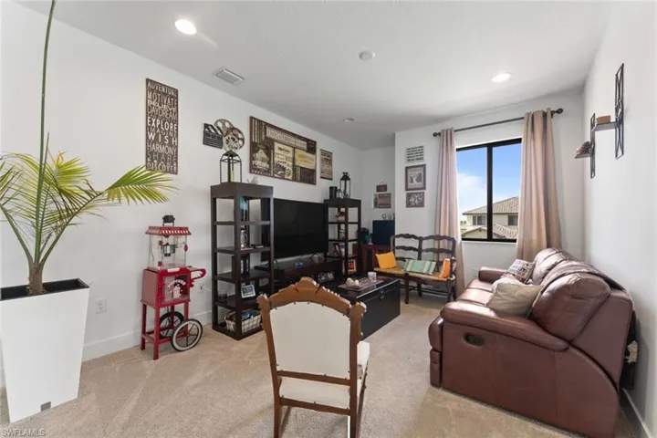 Living room featuring recessed lighting, visible vents, carpet flooring, a textured ceiling, and baseboards
