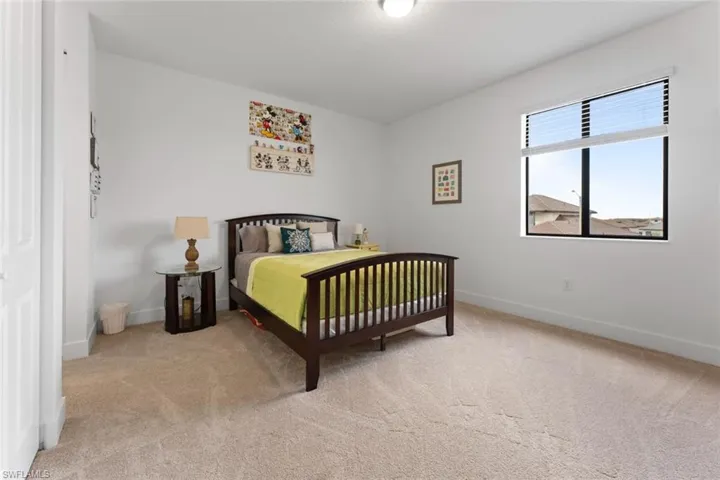Carpeted bedroom featuring baseboards