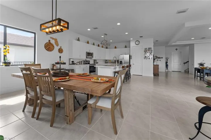 Dining room with light tile patterned floors, visible vents, and recessed lighting